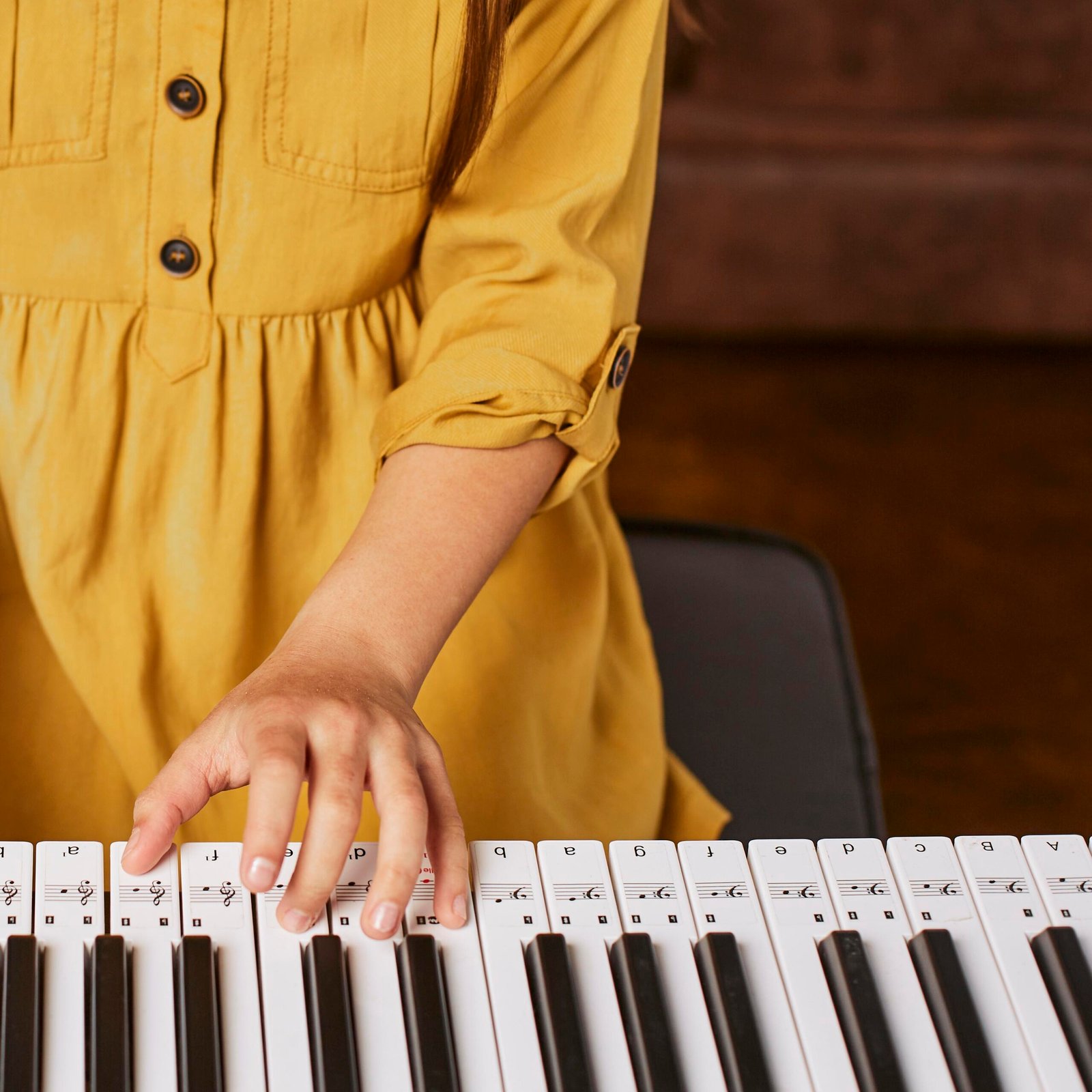 young-girl-learning-how-play-electronic-keyboard-home